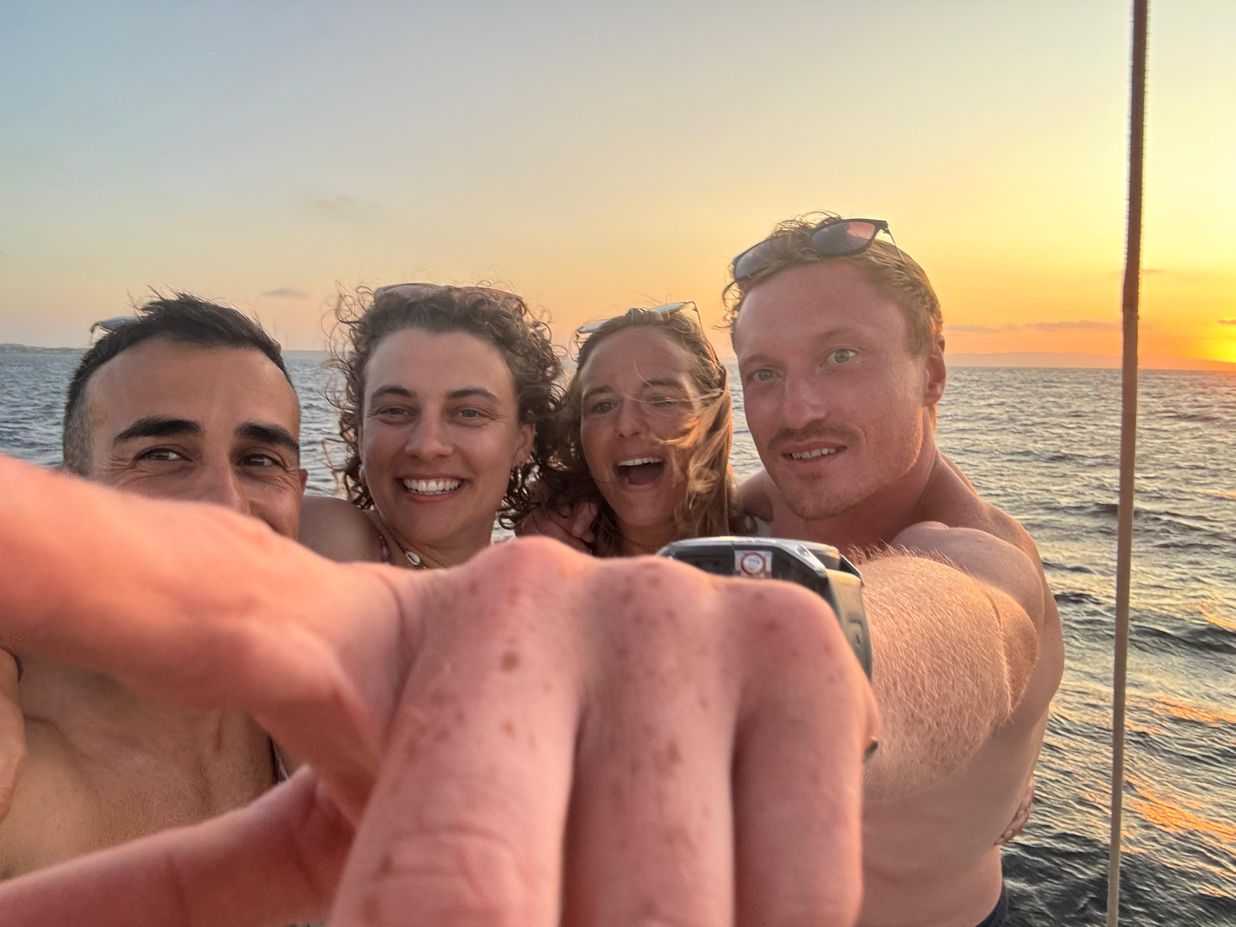 Friends enjoying sunset on a boat in the Caribbean